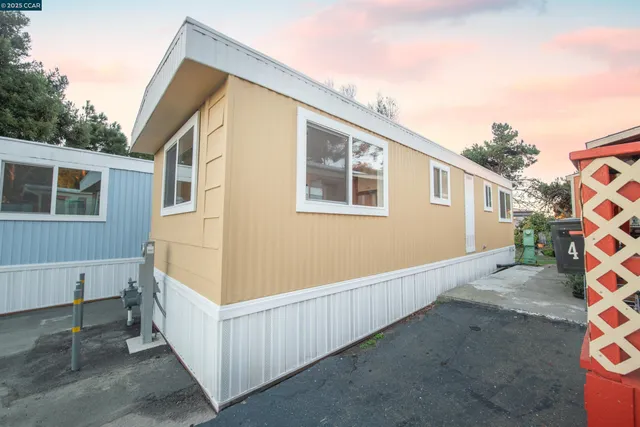 a view of a house with a wooden fence