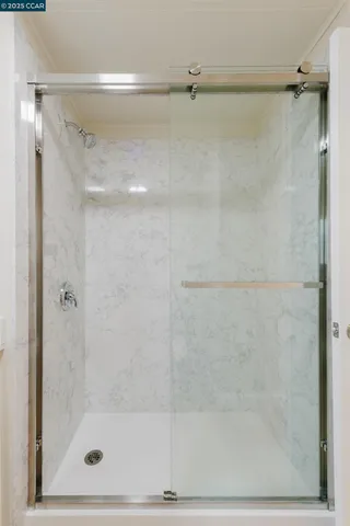 a bathroom with a glass shower door