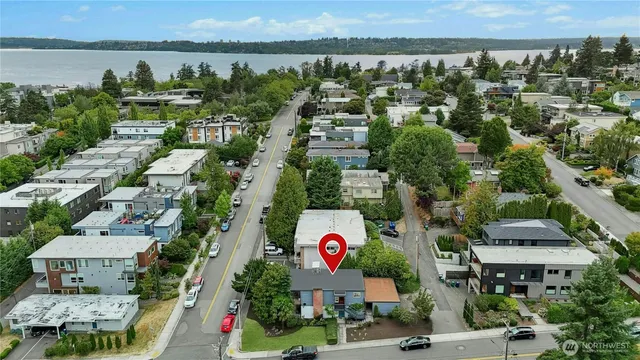 an aerial view of residential houses with outdoor space and parking