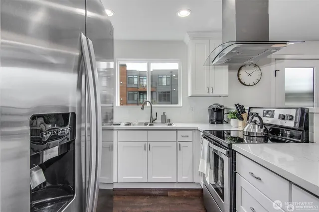 a kitchen with stainless steel appliances granite countertop a refrigerator and a sink