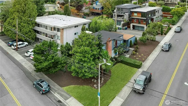 an aerial view of a house with garden space and street view