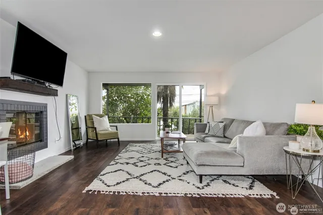 a kitchen with a sink dishwasher a stove and white cabinets with wooden floor