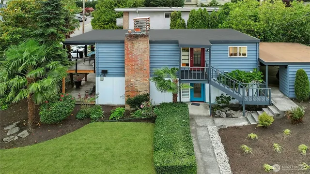 a couple of palm trees in front of a house