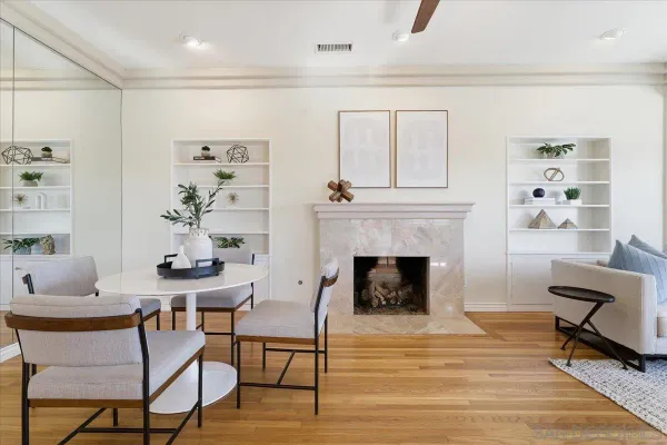 a living room with furniture and a kitchen view