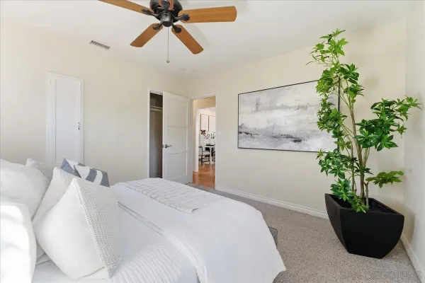 a bedroom with a bed and a large window