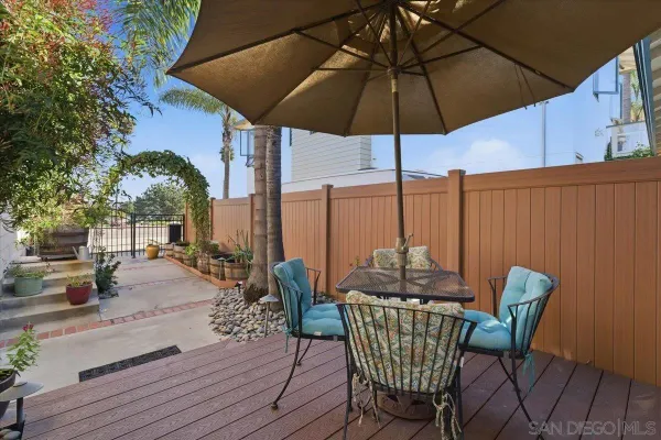 a kitchen with stainless steel appliances granite countertop a table chairs refrigerator and a sink