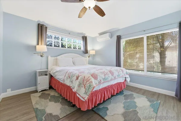 a bedroom with a bed and a flat tv screen in it