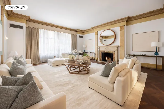 a living room with furniture a fireplace and a large window