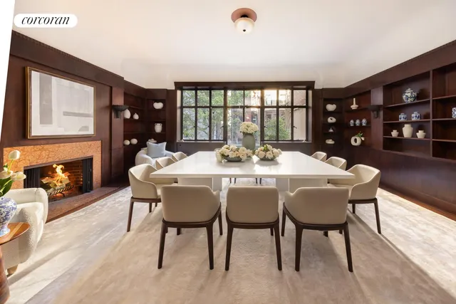a living room with furniture a fireplace and a large window