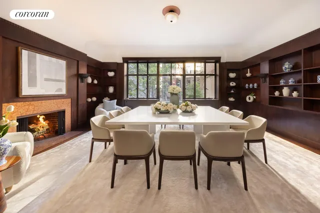 a living room with furniture a fireplace and a large window