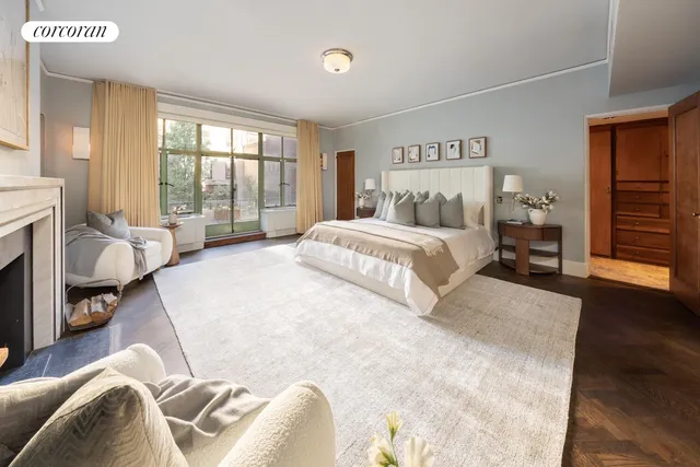 a spacious bedroom with a bed and a fireplace