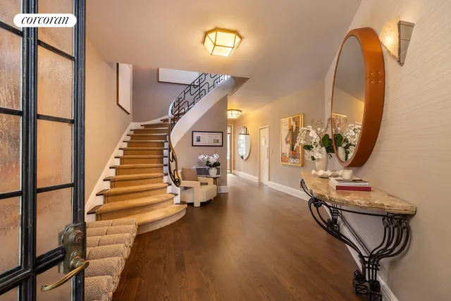 a living room with furniture flowerpot and wooden floor