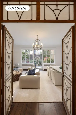 a living room with furniture a fireplace and a chandelier