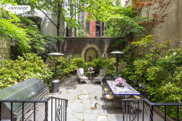a backyard of a house with lots of green space and fountain