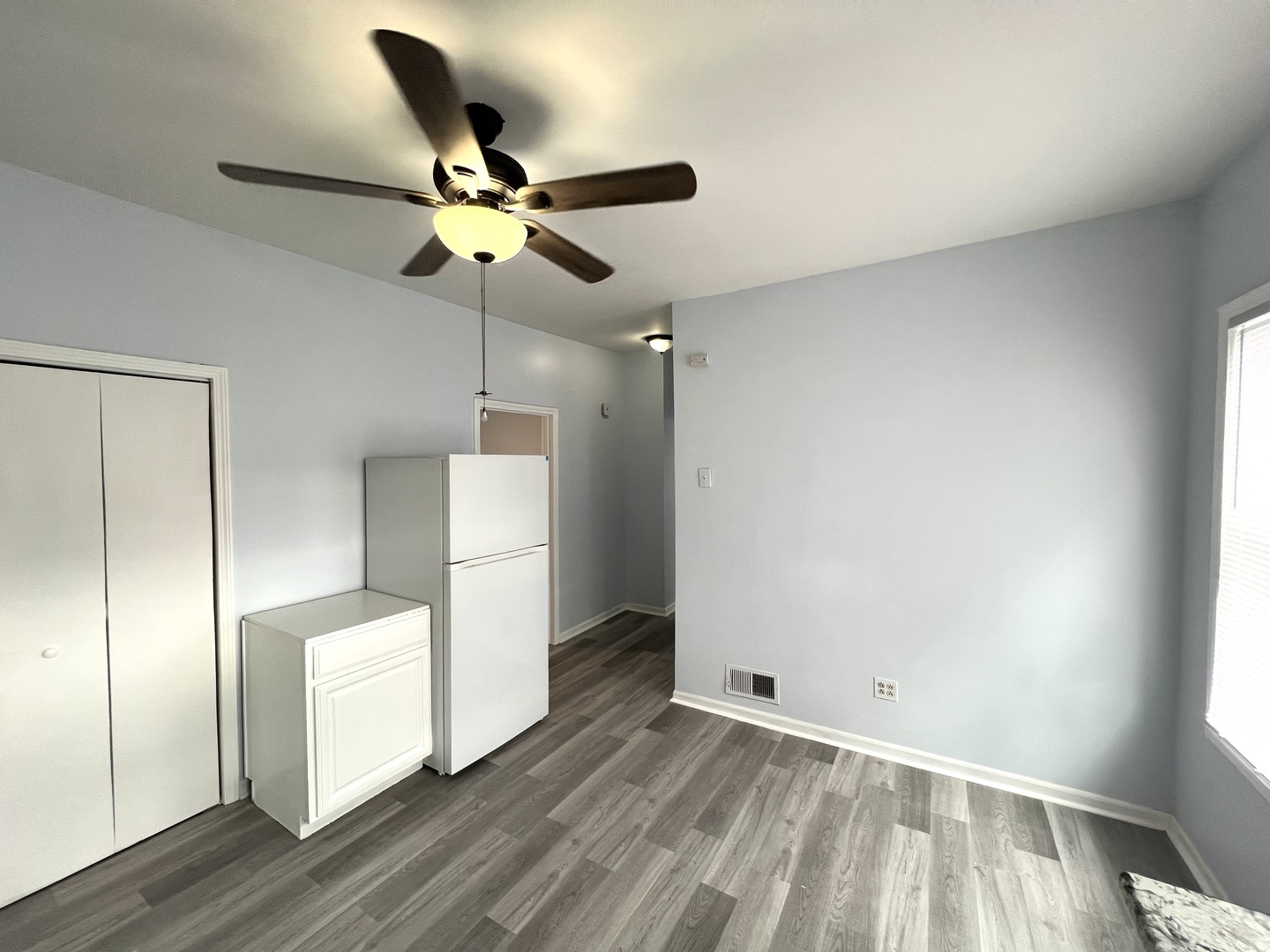 3002 Green Street, Unit 1 Steger, IL 60475 - Photo 12 of 29 a view of a room with wooden floor and ceiling fan