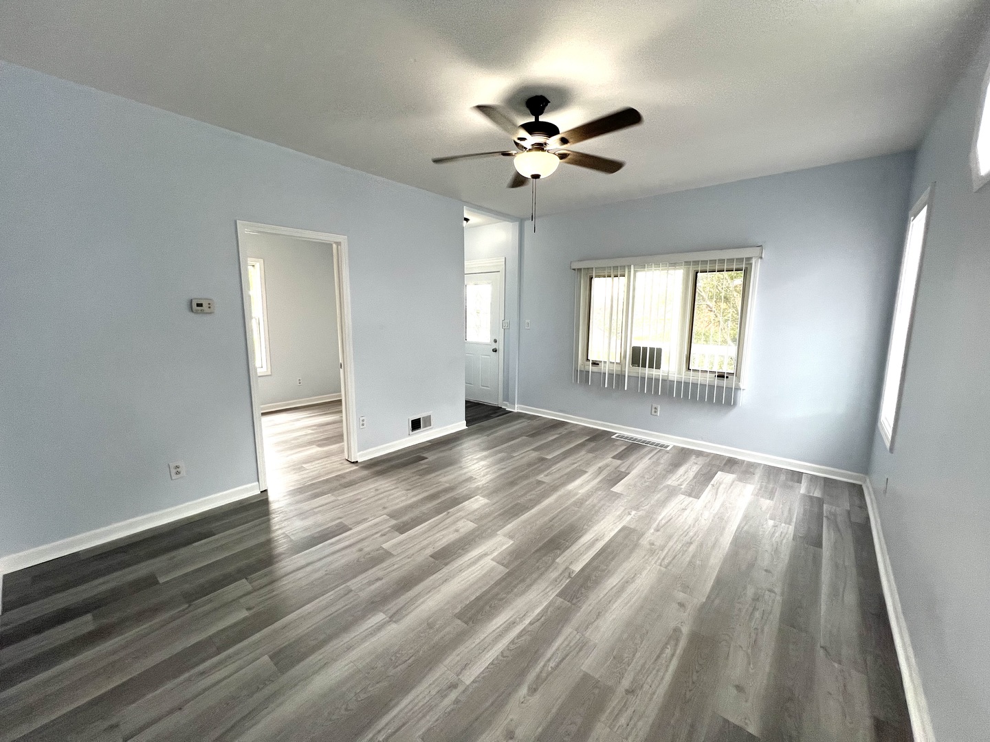 3002 Green Street, Unit 1 Steger, IL 60475 - Photo 14 of 29 a view of empty room with wooden floor and fan