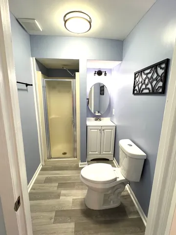 a white toilet sitting next to a bathroom sink