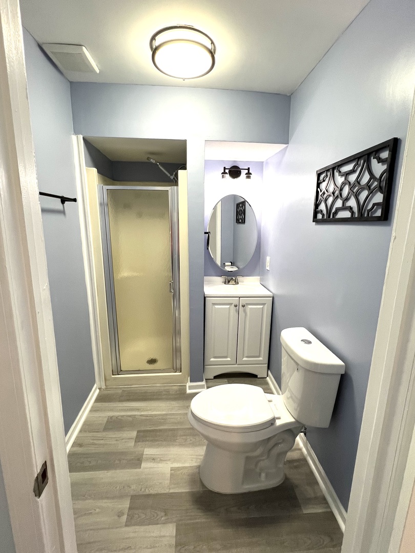 3002 Green Street, Unit 1 Steger, IL 60475 - Photo 16 of 29 a white toilet sitting next to a bathroom sink