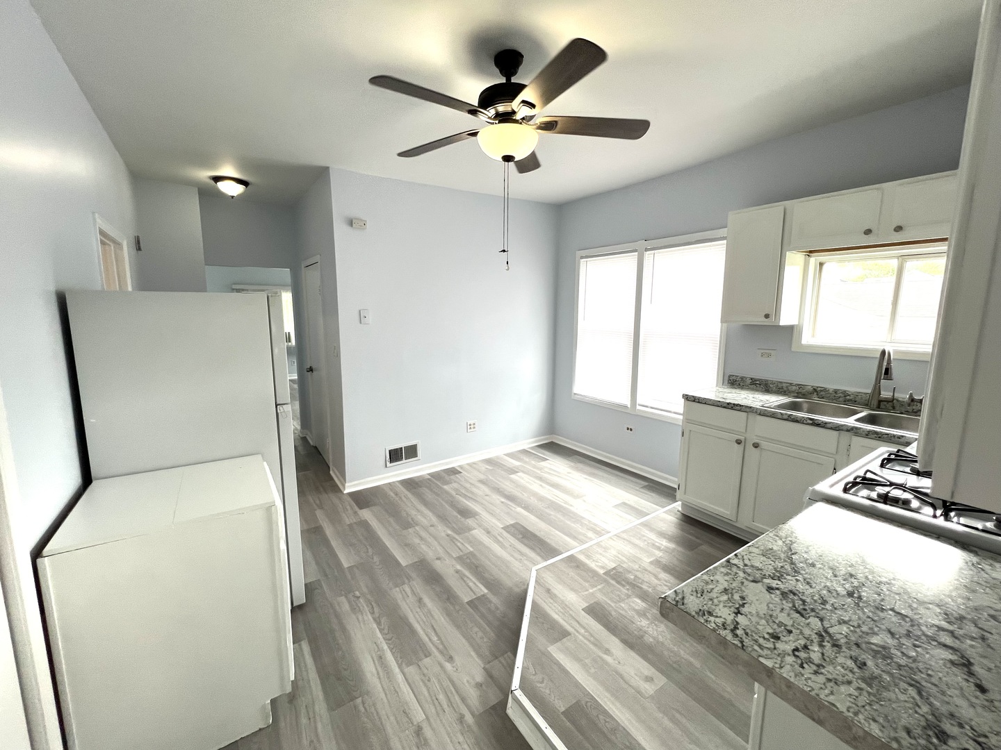 3002 Green Street, Unit 1 Steger, IL 60475 - Photo 7 of 29 a view of a kitchen with cabinets stainless steel appliances and a large window