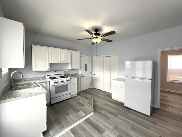 a kitchen with a refrigerator a stove a sink and a microwave