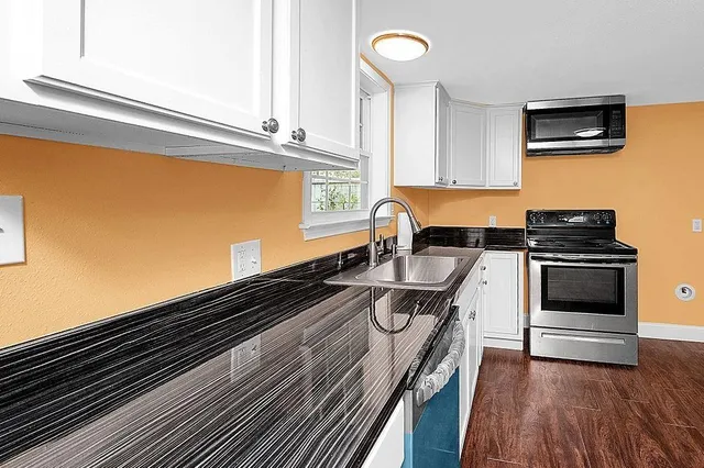 a kitchen with a sink and a stove top oven