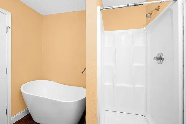 a white tub sitting next to a shower