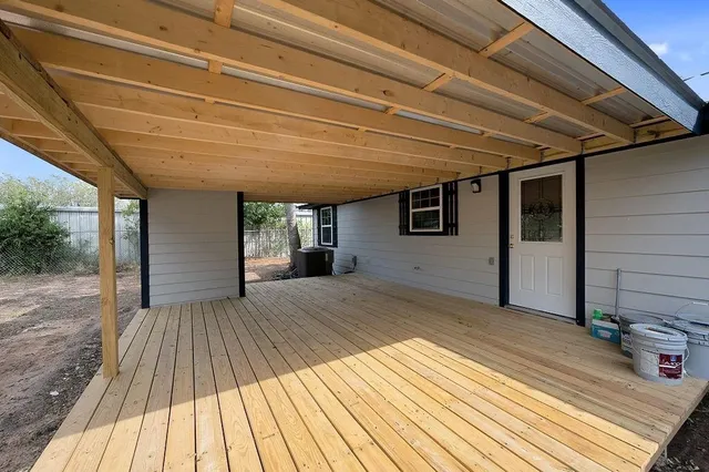 a view of backyard with a wooden deck