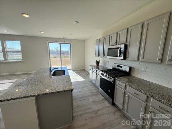 a kitchen with a sink and a vanity