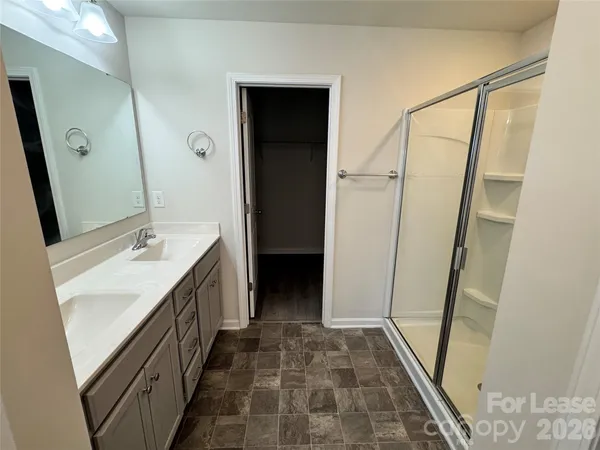 a bathroom with a double vanity sink a and mirror