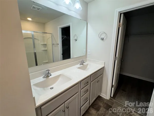 a bathroom with a glass shower door and mirror
