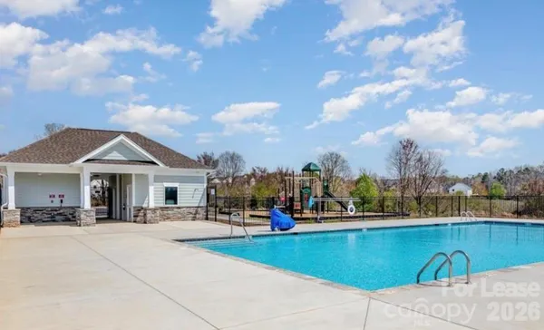 a view of outdoor space with swimming pool and sitting area