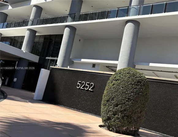 a living room with furniture and floor to ceiling windows