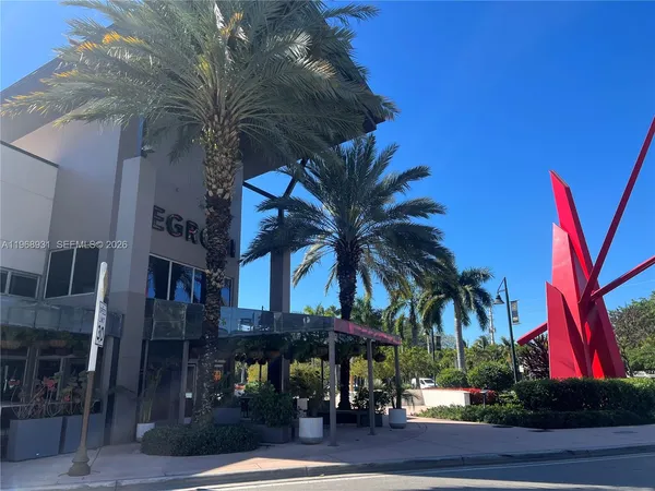 a view of a yard and palm trees