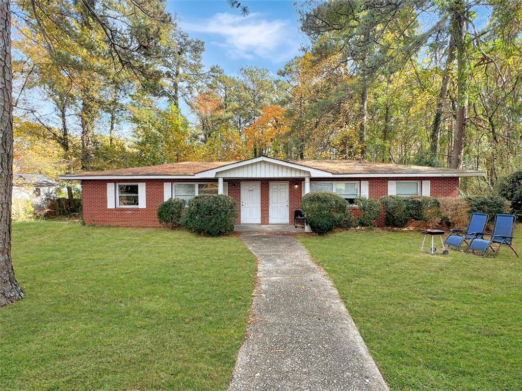 5869 Old Gordon Road Mableton, GA 30126 - Photo 1 of 1 a front view of a house with a yard and trees