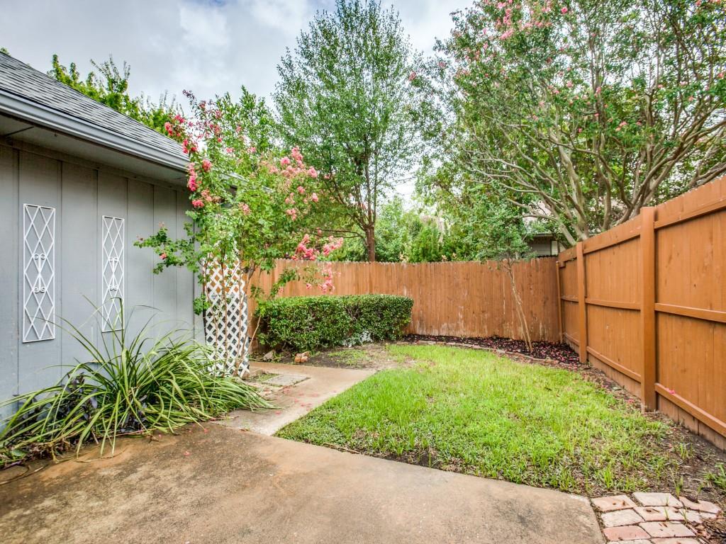 10620 Sandpiper Lane Dallas, TX 75230 - Photo 11 of 12 a view of a backyard with plants and a large tree