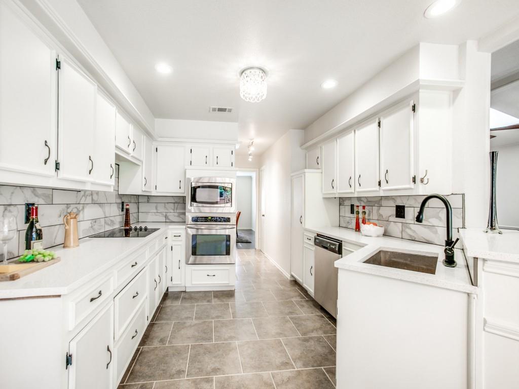 10620 Sandpiper Lane Dallas, TX 75230 - Photo 2 of 12 a kitchen with stainless steel appliances granite countertop a sink and cabinets