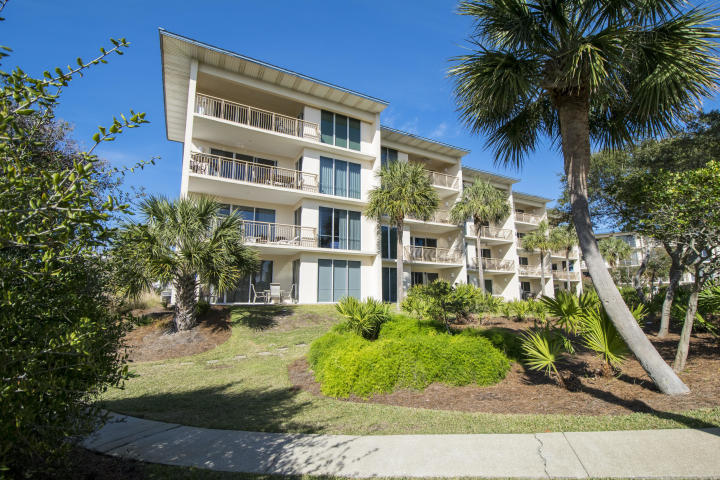 10254 East Co Highway, Unit 135 Inlet Beach, FL 32461 - Photo 1 of 10 a front view of a multi story residential apartment building with yard and green space