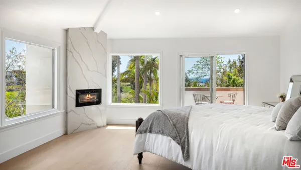 a bedroom with a bed and a fireplace