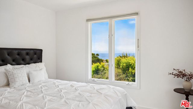 a bed room with a bed and a window