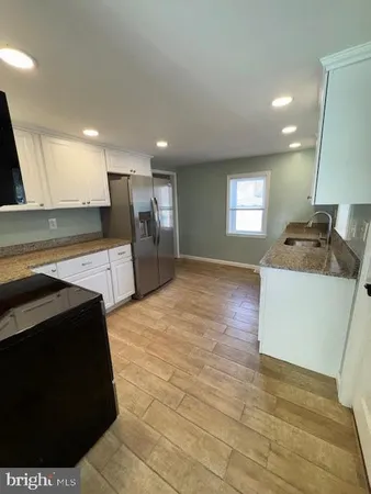 a kitchen with stainless steel appliances a refrigerator sink and stove