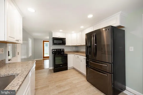 a kitchen with a refrigerator and a sink