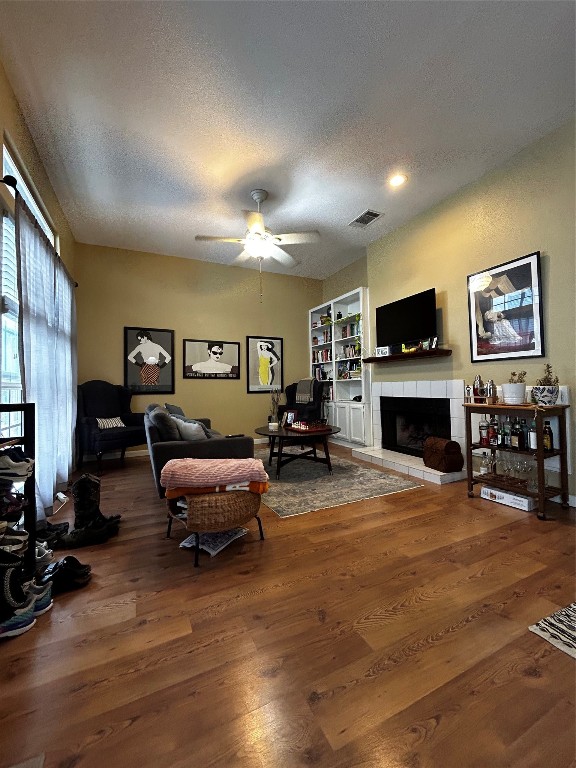 a living room with furniture a fireplace and a flat screen tv