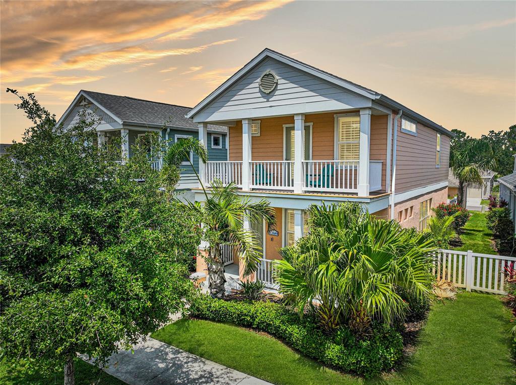 a front view of a house with a yard and potted plants