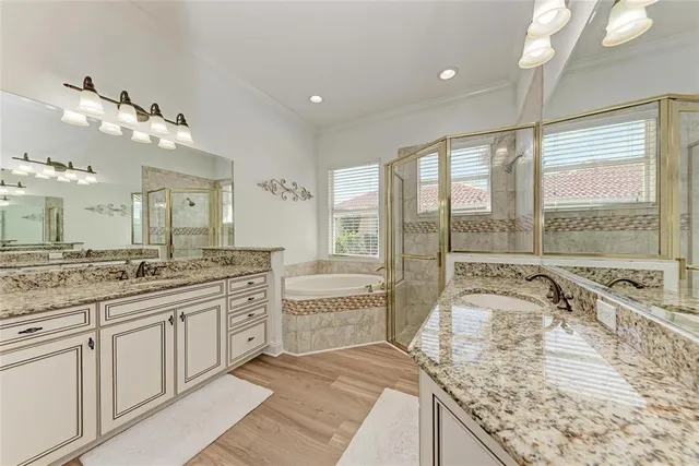 a large kitchen with kitchen island a large window a sink and cabinets