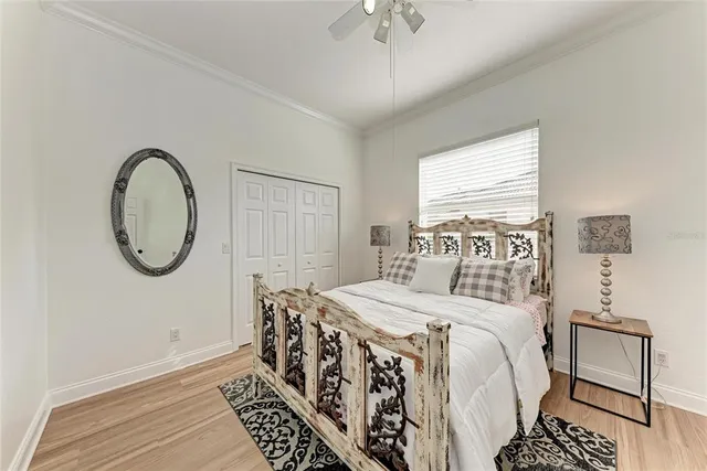 a bedroom with a bed and a chandelier