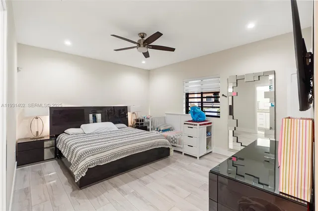 a bedroom with a bed and wooden floor