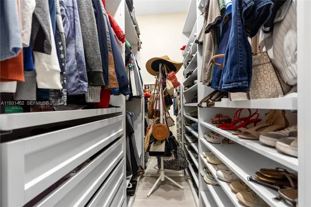 a bathroom with a granite countertop sink a toilet a mirror a bathtub and shower