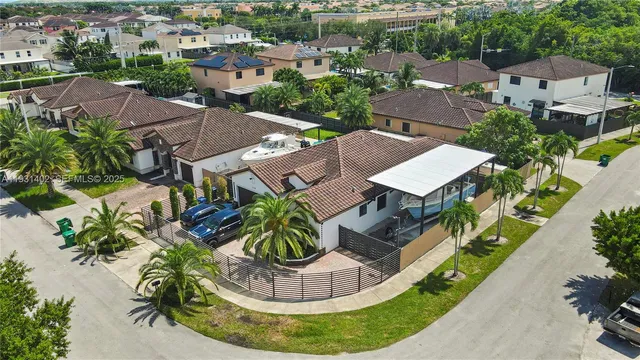 a view of a house with a yard and potted plants