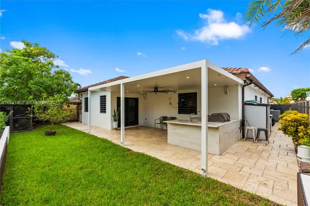 a view of a kitchen with appliances and furniture