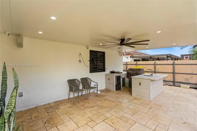a patio area with bunch of trees in the background